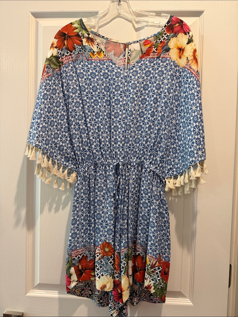Farm Rio romper with floral design and geometric tassel kimono sleeve.